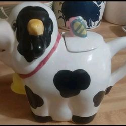 This is a cow-shaped teapot, likely made of ceramic. All Tea Pots From Collectio