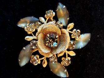 $10. Goldtone brooch with gray glass rhinestones. 2 in diameter. No Hallmark.