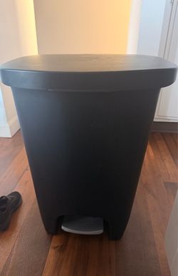 Black plastic trash can