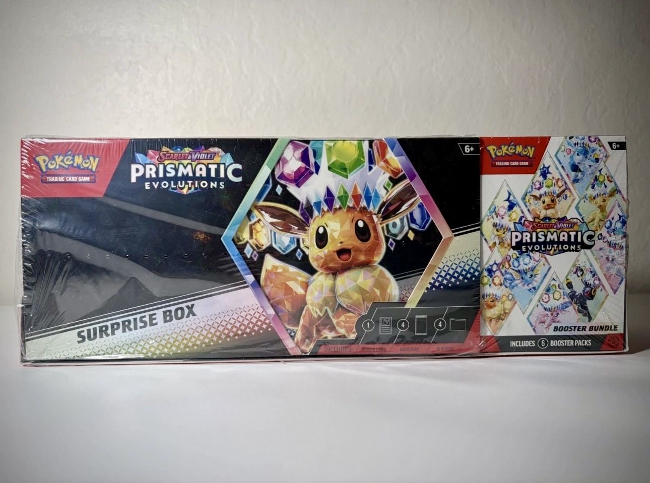 Pokémon Prismatic Evolutions Surprise Box + Booster Bundle