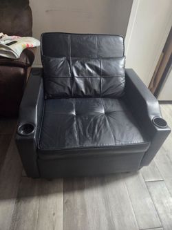 Two piece black leather recliner/Bed