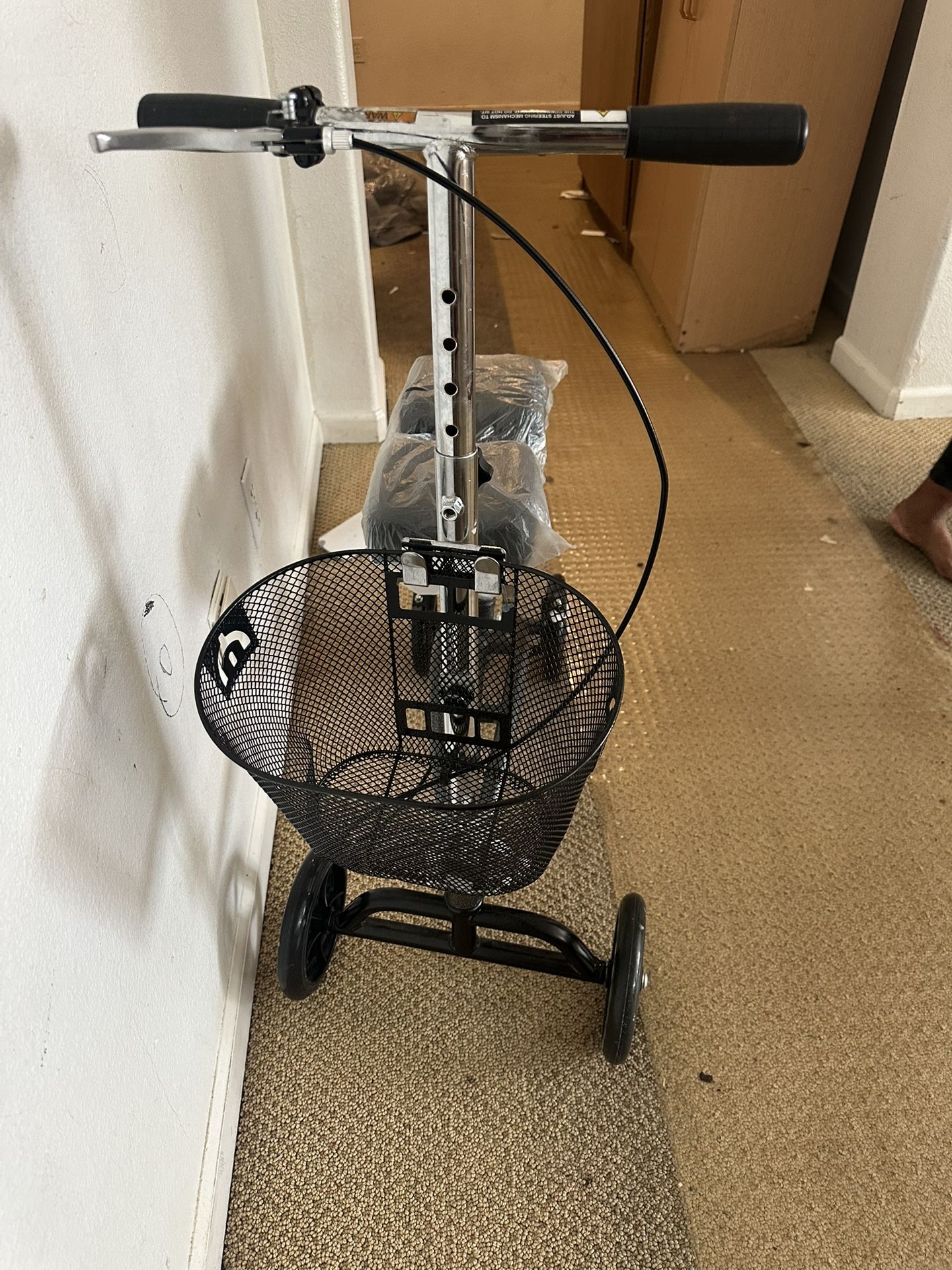 Brand new Drive Medical Dual Pad Steerable Knee Walker with Basket, also known as a knee scooter in black