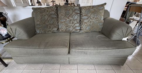 Green Sofa with Patterned Cushions