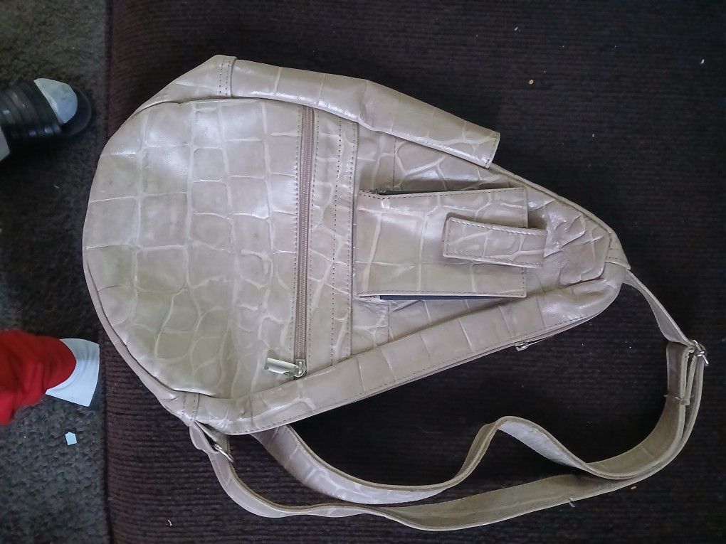 Purse backpack with a cell phone holder.