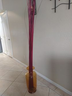 Glass jar with red sticks