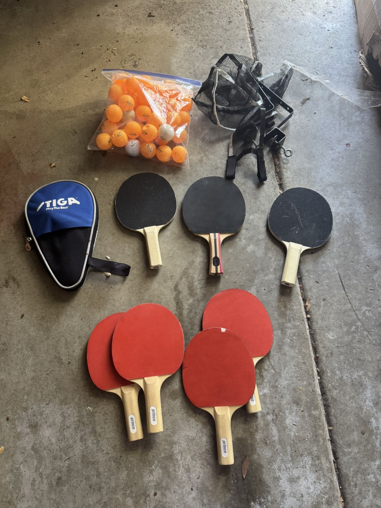 Ping pong paddles, balls, and net 