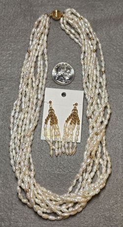 Vintage 10 strand freshwater rice cultured pearls necklace.  Gold bead accents.  Includes earrings.
