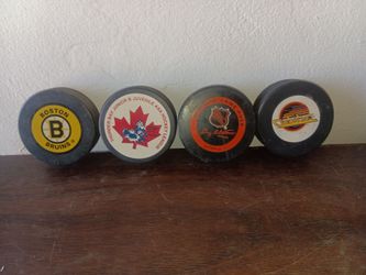 For total hockey pucks Boston bruins Vancouver Canucks two NHL pucks one game used!