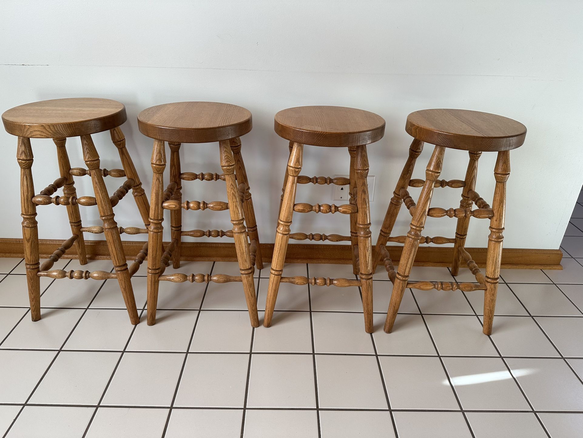 Four Amish Made Solid Oak Bar Stools.