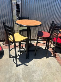 Durable commercial-grade restaurant furniture set includes both standard and bar-height tables. The tables have wood-grain laminate tops with protecti