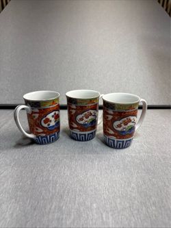 These are Takahashi Imari porcelain mugs, a vintage 1970s Japanese set featuring vibrant red and blue floral motifs with gold