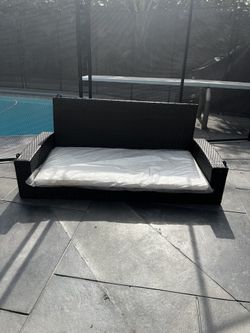 Patio Swing With White Cushions