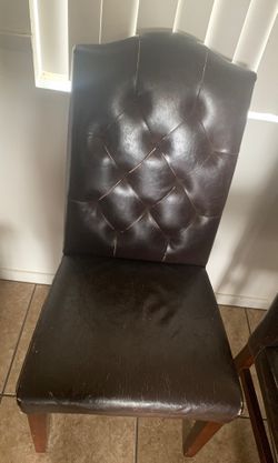 6 leather chairs and one black bar chair