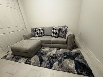 Grey fabric couch with ottoman