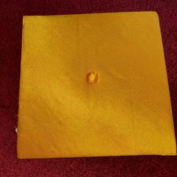 Gold Graduation Cap  	•	Description: Square-top gold graduation cap with an elasticized fit.
