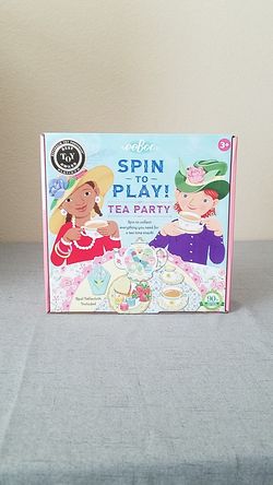 Spin to play Tea Party Board Game ages 3 and up real tablecloth included
