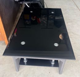 modern black glass coffee table with a lower shelf