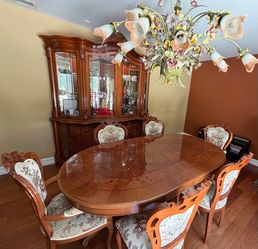 Pulaski curio/china cabinet, dining table and hand carved chairs.