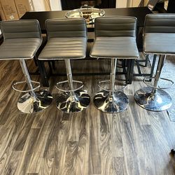 Adjustable grey and sliver stools.