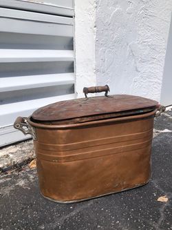 An antique copper washing boiler