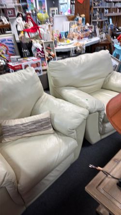 Cream colored leather chairs, black leather chairs