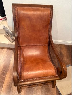 2 leather chairs with pillows