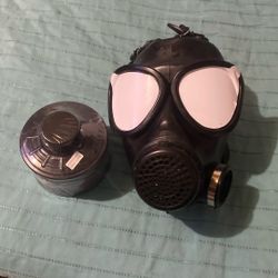  black full-face gas mask with a separate filter canister