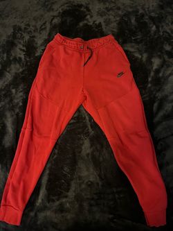 Red Nike tech pants size M