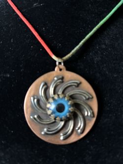 Glass eye over brass antique collectable items hand crafted and signed by American glass artist G. Fone with adjustable colorful cloth string. 2” x 1.