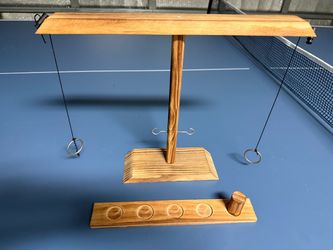 The Wood Tabletop Ring & Hook Toss Game is a classic and challenging game suitable for ages 17 and up. Made from high-quality brown wooden materials, 