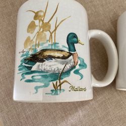 The NOS Vintage Japan DE Miller Duck Coffee Mugs are a charming set of four-piece ceramic and porcelain mugs featuring a ducks pattern, specifically m