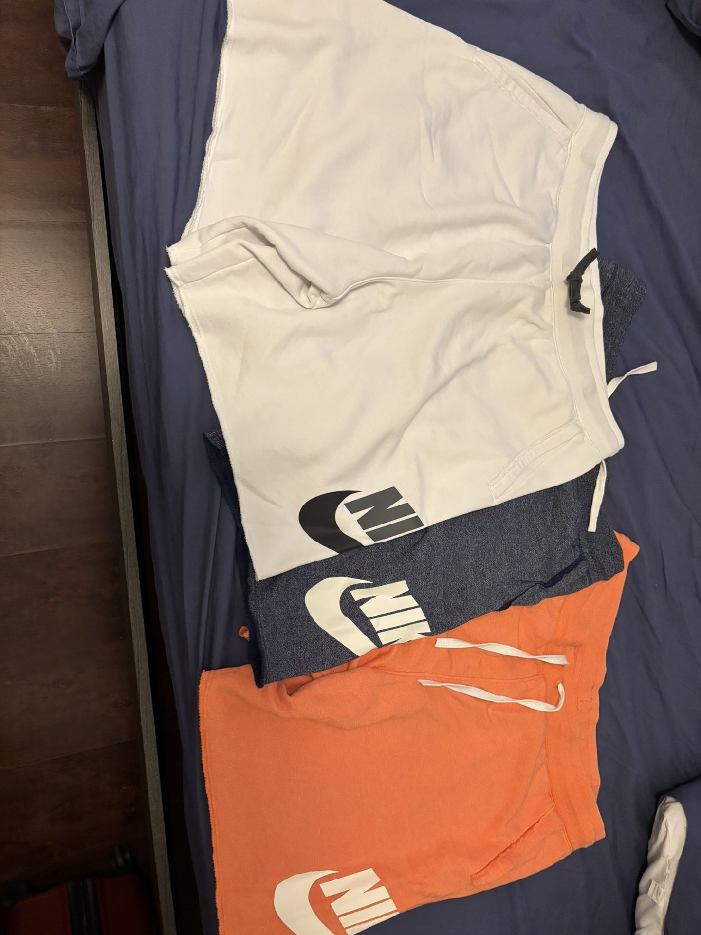 3 Nike shorts XL (orange/white) and L (blue)