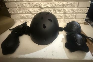 Black Helmet and Protective Gear Set Includes helmet, knee pads, and elbow pads.