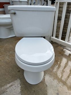 toilet in good condition; measures 15 inches in height.