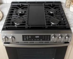 GE profile stainless set fridge gas stove and over the range microwave