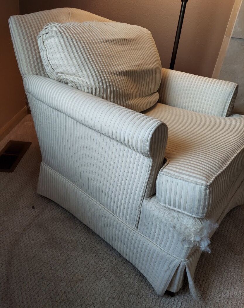 Upholstered armchair with striped beige upholstery