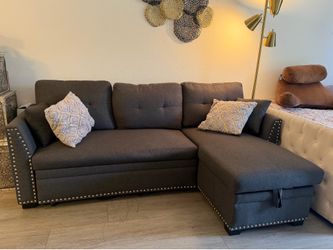 Almost new lift top storage with pull out sleeper couch
