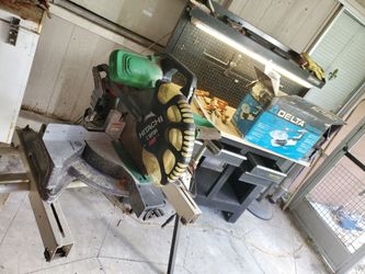 Work bench,chop saw and scroll saw and another .