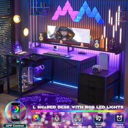 Double-sided L-shaped computer desk gaming desk with power sockets and LED light strip, storage rack, black