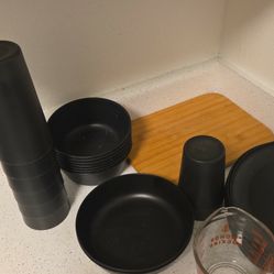 plastic plates, cups, cutting board measuring cup