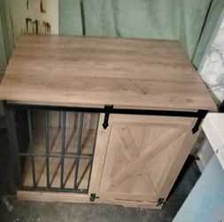 A wooden dog crate stand