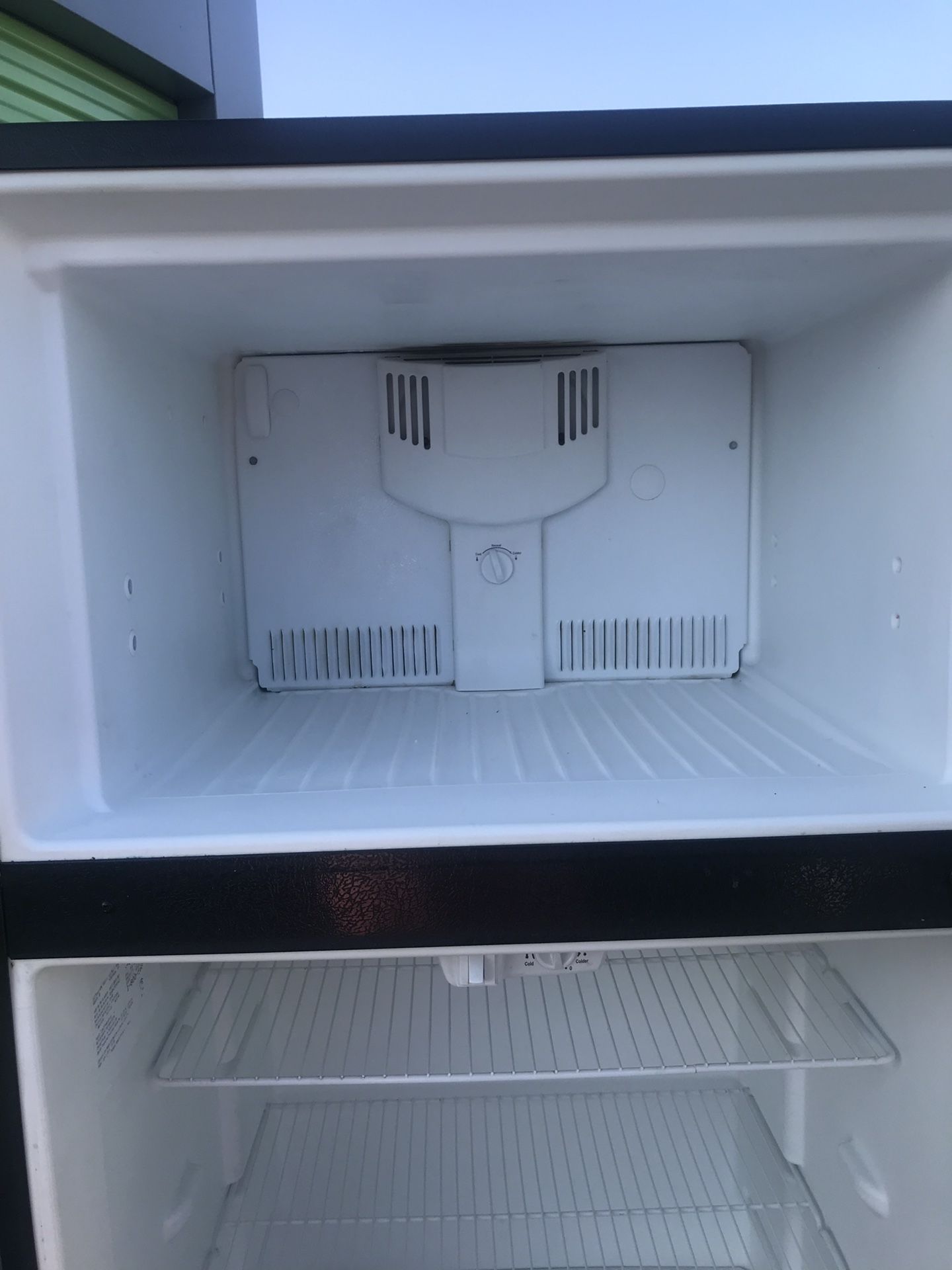 Stainless steel and black apartment full size Frigidaire refrigerator