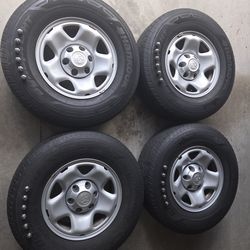 4 - 16 inch Toyota Tacoma OEM wheels and center caps (excellent condition), original tires (P225/75R16 with approximately 7,500 miles of use remaining