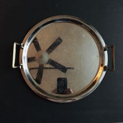 Vintage Antique. Round metal tray with 2 Yellow Metal handles. Like new condition. Diameter: 12.75”.