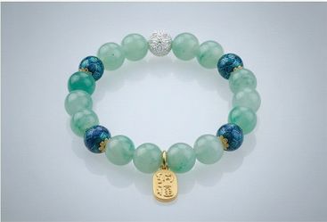 A pure natural light green beaded bracelet. Each smooth and polished bead presents a soft and serene green hue, symbolizing peace and harmony. Connect
