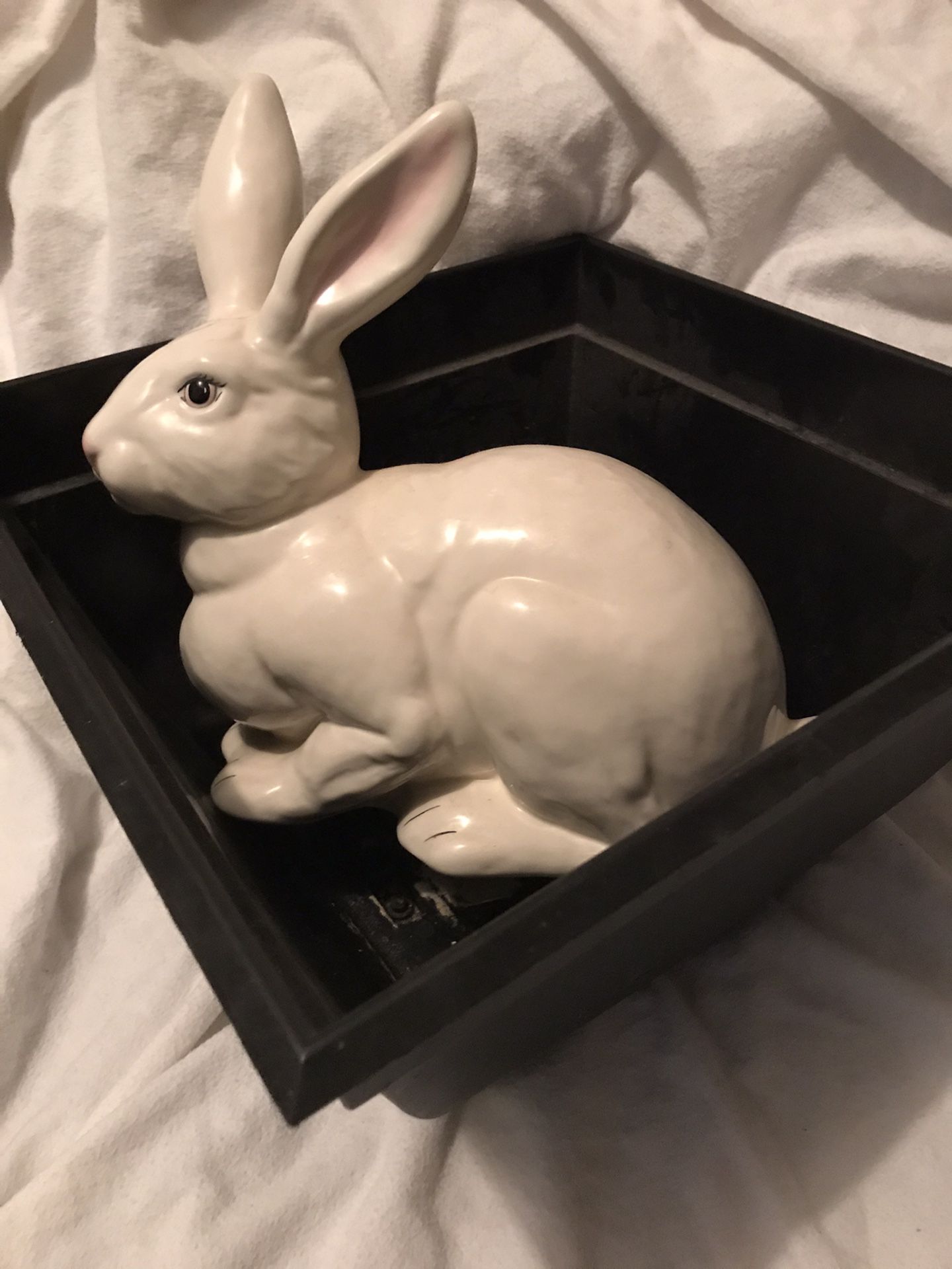 Ceramic rabbit and black flower pot together