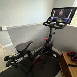 Peloton bike w/shoes, mat, & accessories - barely used (50 Hour Ride Time)