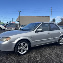 002 Mazda Protegé DX Sedan  • 181,000 miles • 4-cylinder engine • 5-speed manual transmission • Sunroof • Clean title • Runs and drives great  Reliabl
