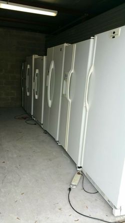 White and black side by side refrigerators