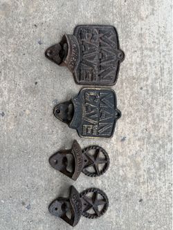 Set of (4) cast iron bottle openers.